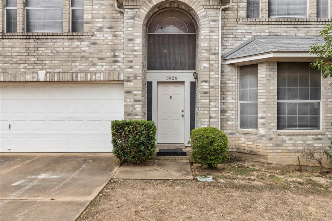 3929 Katzman Drive Austin, TX 78728 - Photo 3 of 29 a view of a brick house with potted plants