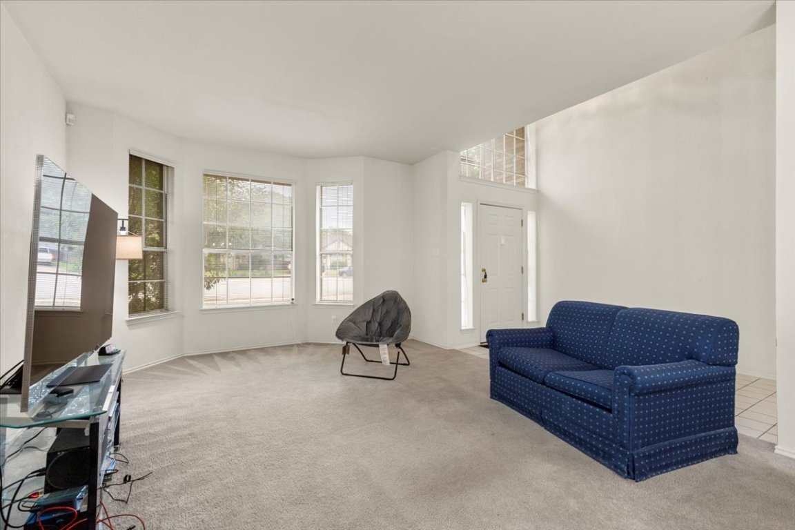 3929 Katzman Drive Austin, TX 78728 - Photo 5 of 29 a living room with furniture a flat screen tv and a window