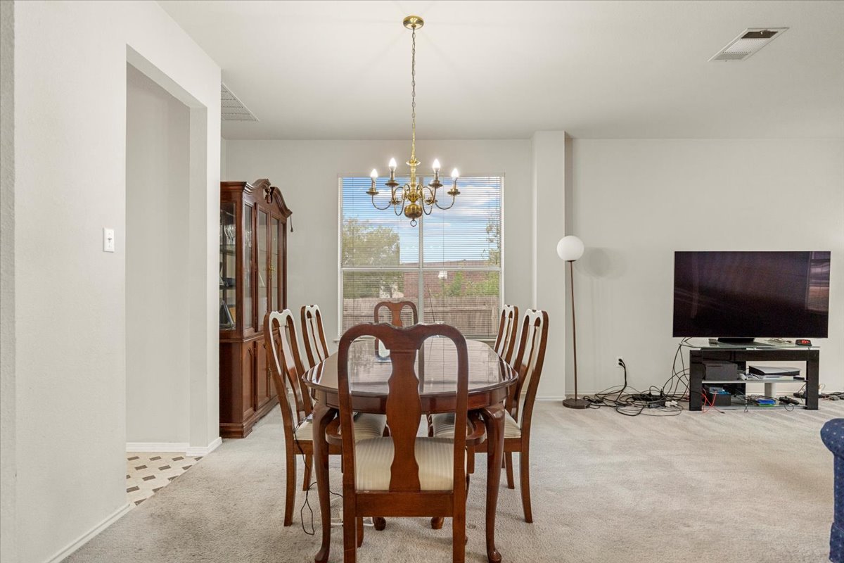 3929 Katzman Drive Austin, TX 78728 - Photo 7 of 29 Dining space featuring light carpet and a chandelier