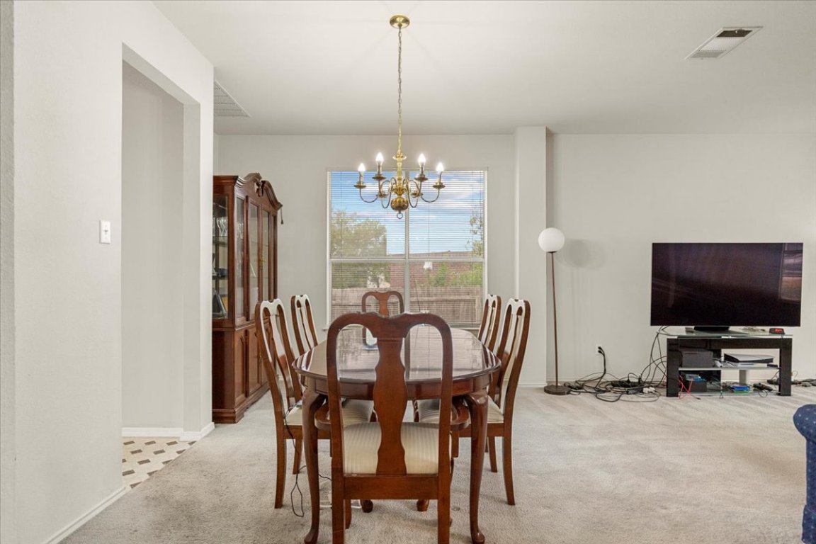 3929 Katzman Drive Austin, TX 78728 - Photo 7 of 29 a view of a dining room with furniture and chandelier