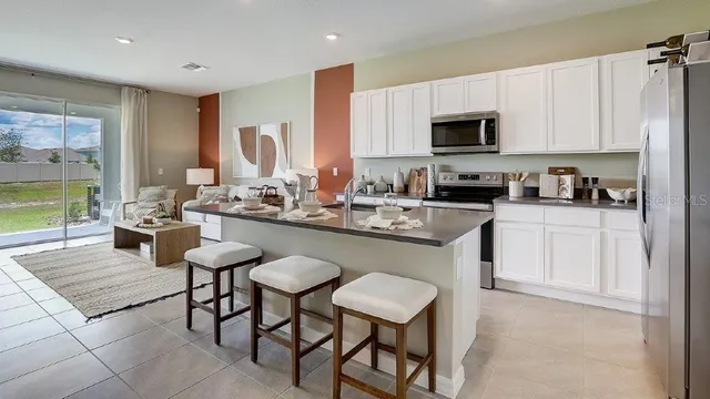 a kitchen with a stove microwave and sink