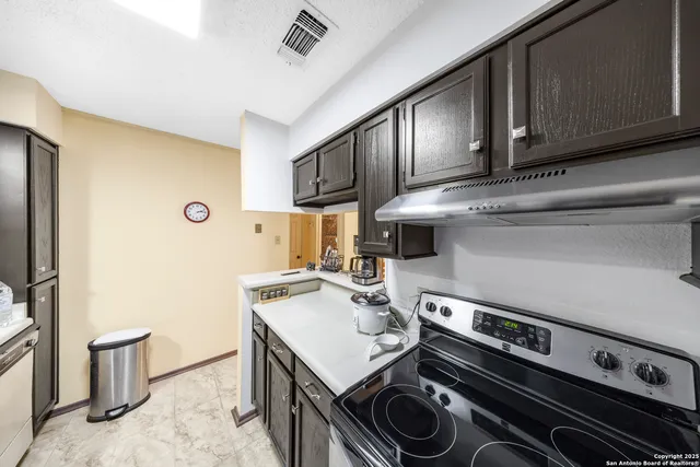 a kitchen with a stove and a sink