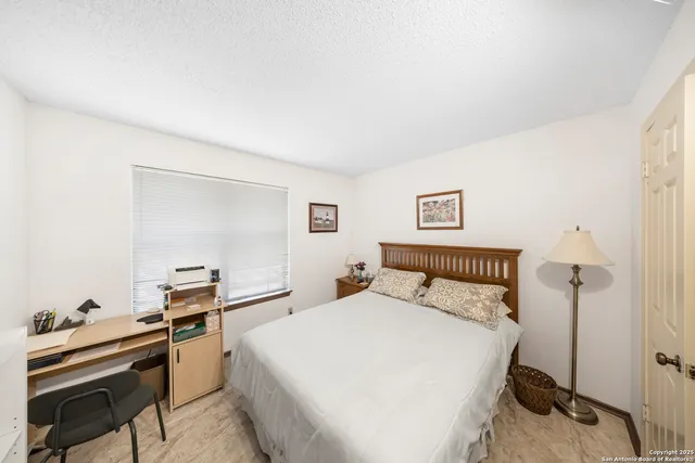 a bedroom with a bed and a desk