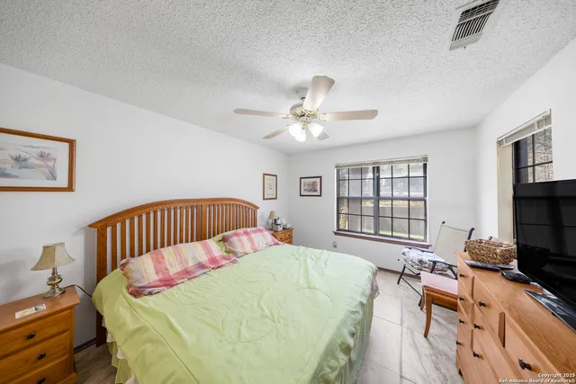 a bedroom with a bed window and a couch