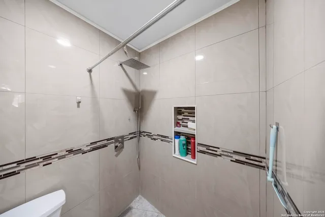 a view of a room with an empty space and a window