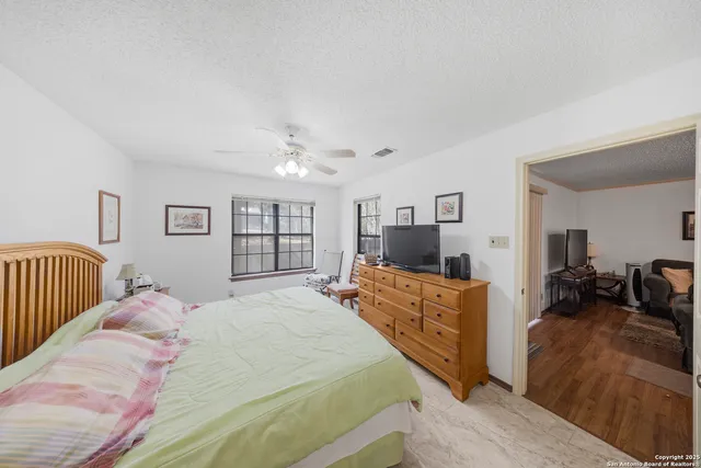 a bed room with two beds and a television