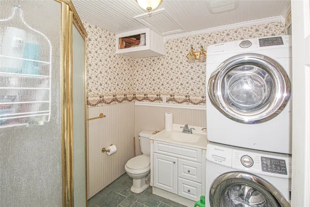 a view of a bathroom with washing machine and sink