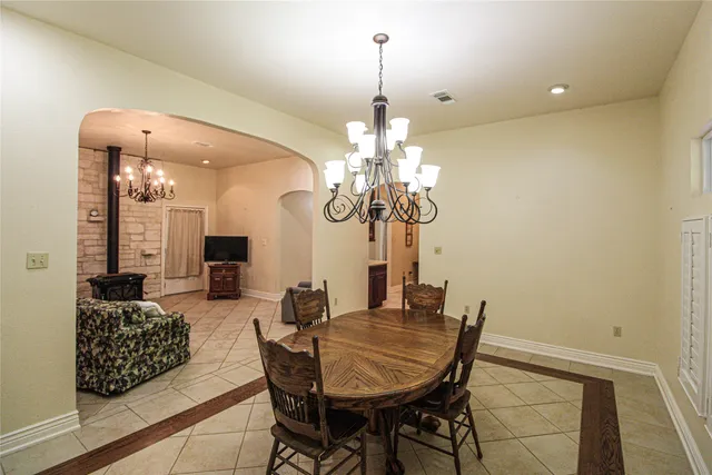 a view of a dining room with furniture and chandelier