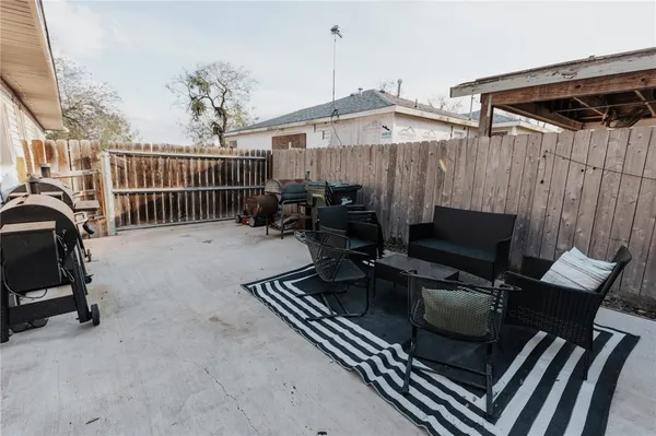 a view of a patio with a table and chairs