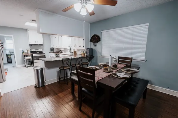 a view of a dining room with furniture and wooden floor