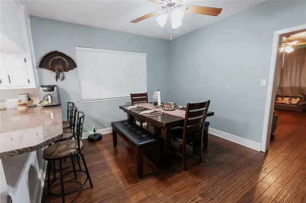 a view of a dining room with furniture and wooden floor