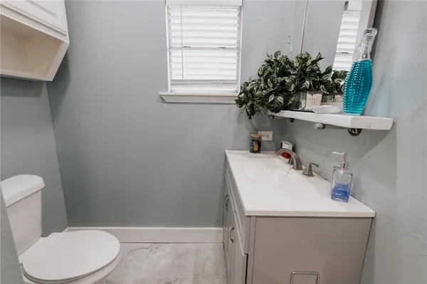 a bathroom with a sink toilet and mirror