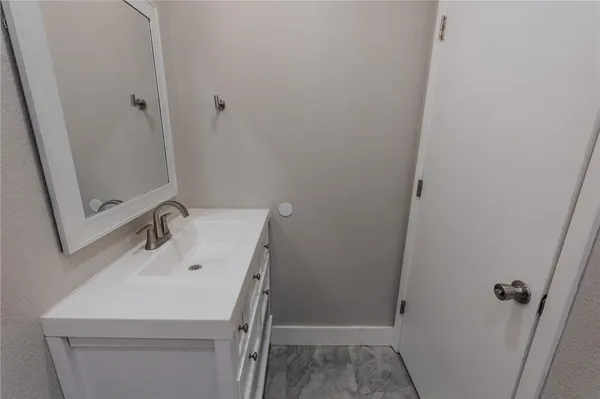 a bathroom with a sink and mirror