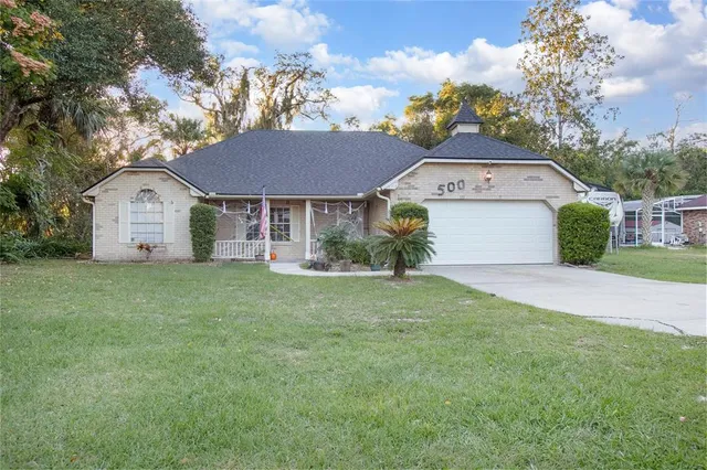 a front view of a house with a garden and plants