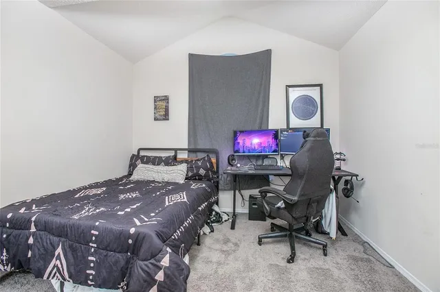 a bedroom with a bed a desk and chair