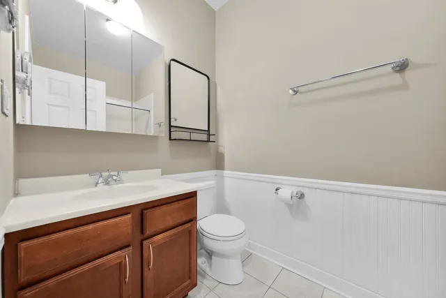 a bathroom with a sink a toilet and vanity