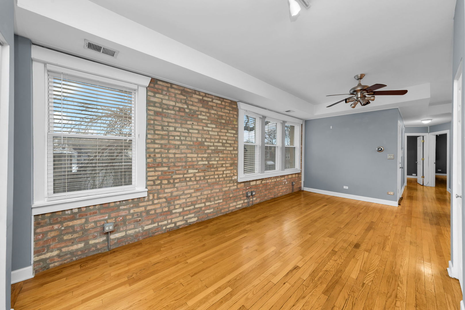 4241 North Kimball Avenue, Unit 2 Chicago, IL 60618 - Photo 8 of 16 a view of an empty room with wooden floor and a window