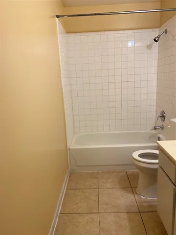 a bathroom with a bathtub and a toilet