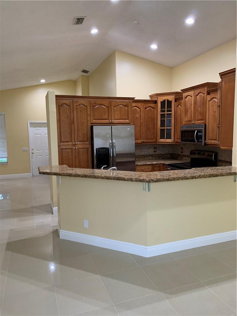 842 Briar Ridge Road Weston, FL 33327 - Photo 1 of 13 a view of kitchen with stainless steel appliances granite countertop refrigerator sink and stove