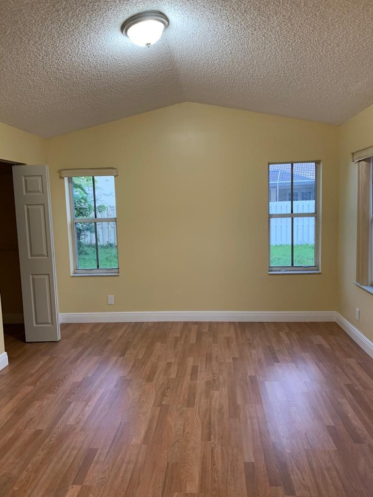 842 Briar Ridge Road Weston, FL 33327 - Photo 4 of 13 an empty room with wooden floor and windows