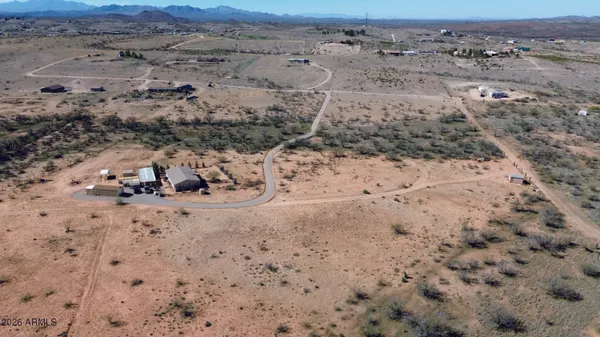 a view of a dry yard with mountain in the background
