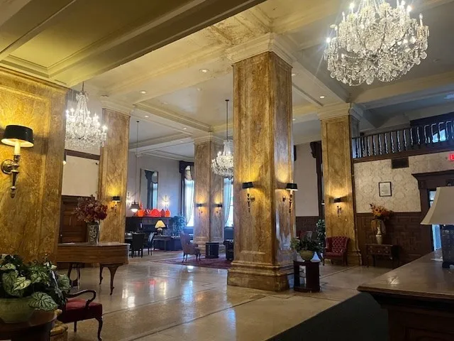 a lobby with furniture and a chandelier