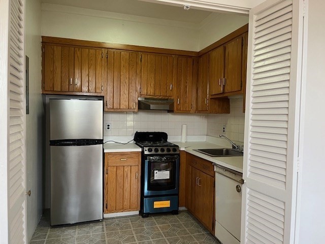 140 Chestnut Street, Unit 402 Springfield, MA 01103 - Photo 7 of 12 a kitchen with a refrigerator and a stove top oven