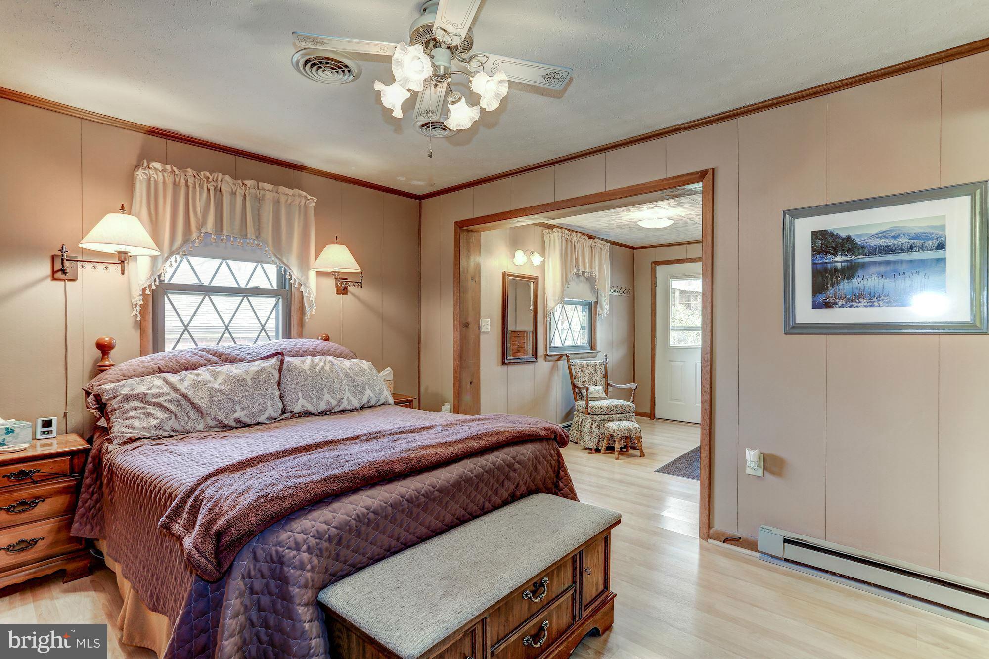 2 Nichols Road Luray, VA 22835 - Photo 9 of 30 a bedroom with a large bed and a chandelier