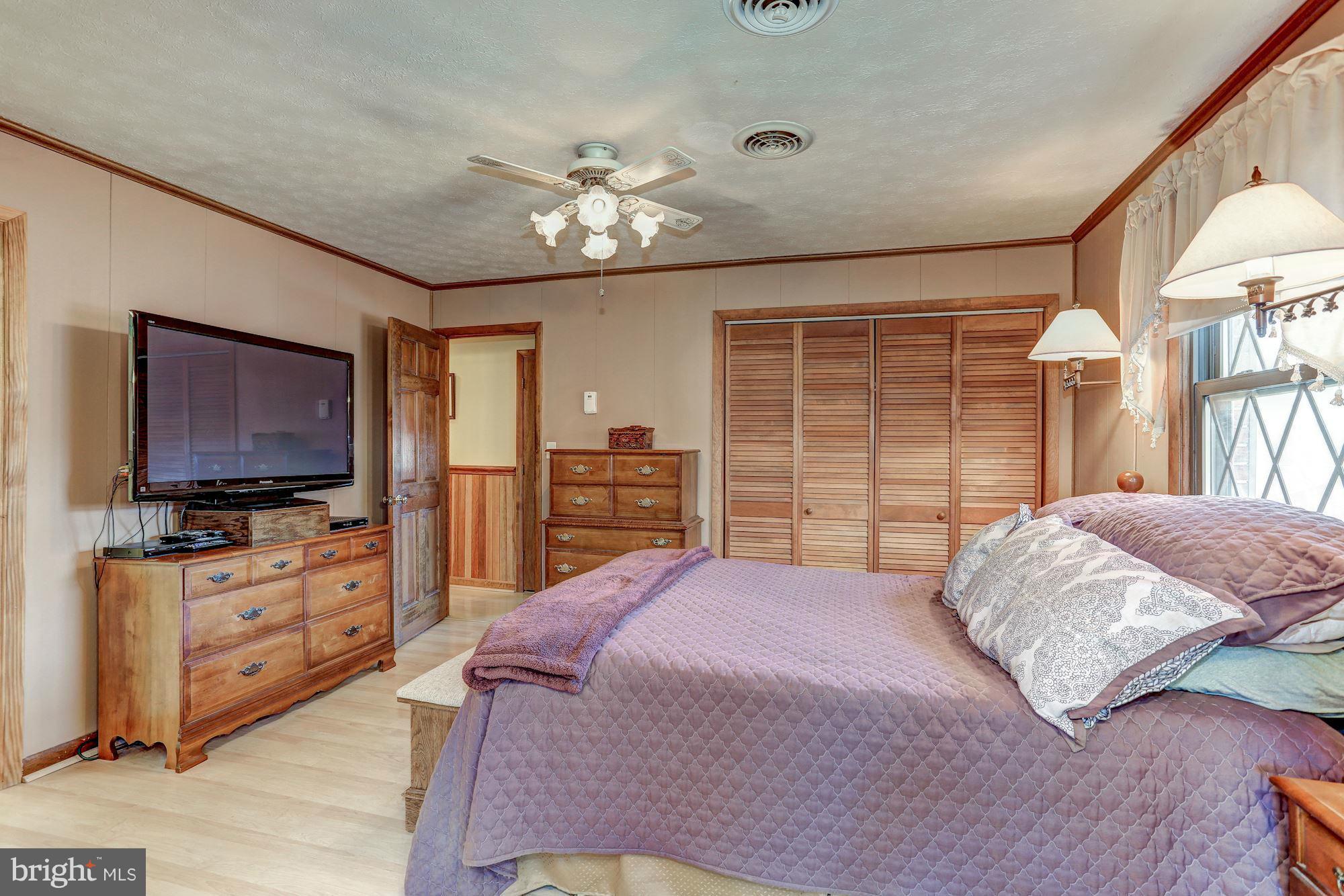 2 Nichols Road Luray, VA 22835 - Photo 10 of 30 a bedroom with a bed dresser and a flat tv screen