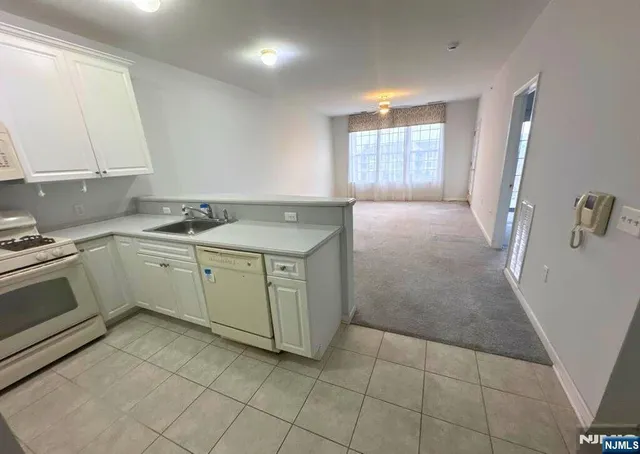a kitchen with a sink cabinets and window