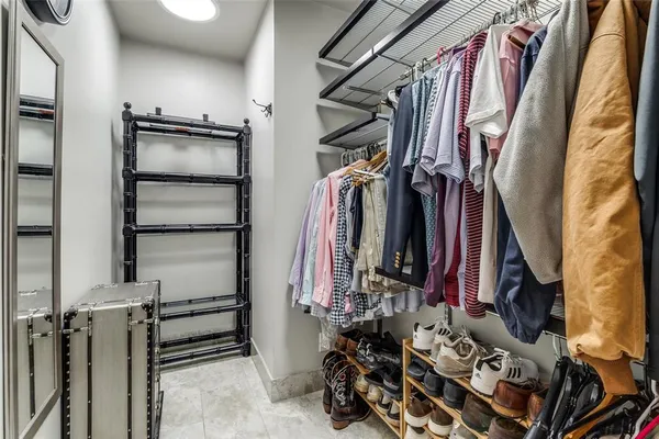 a view of walk in closet with clothes and shoes