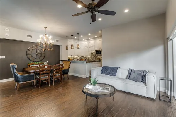 a living room with furniture and a chandelier