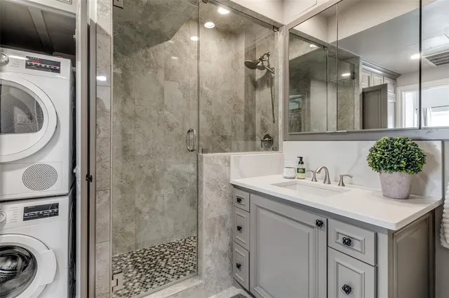 a bathroom with a sink a toilet and shower