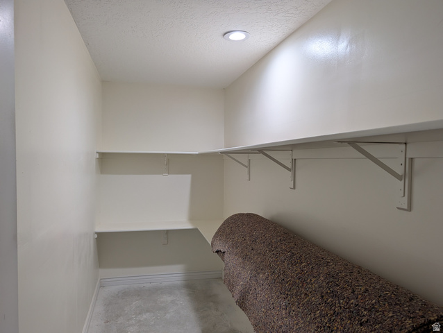 171 South Mustang Road East Grantsville, UT 84029 - Photo 24 of 41 Built-in shelving system with white painted walls and a recessed ceiling light