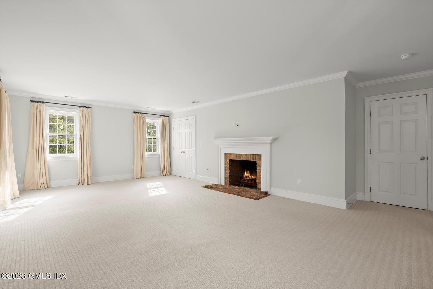31 Fairfield Road Greenwich, CT 06830 - Photo 12 of 28 an empty room with windows and fireplace