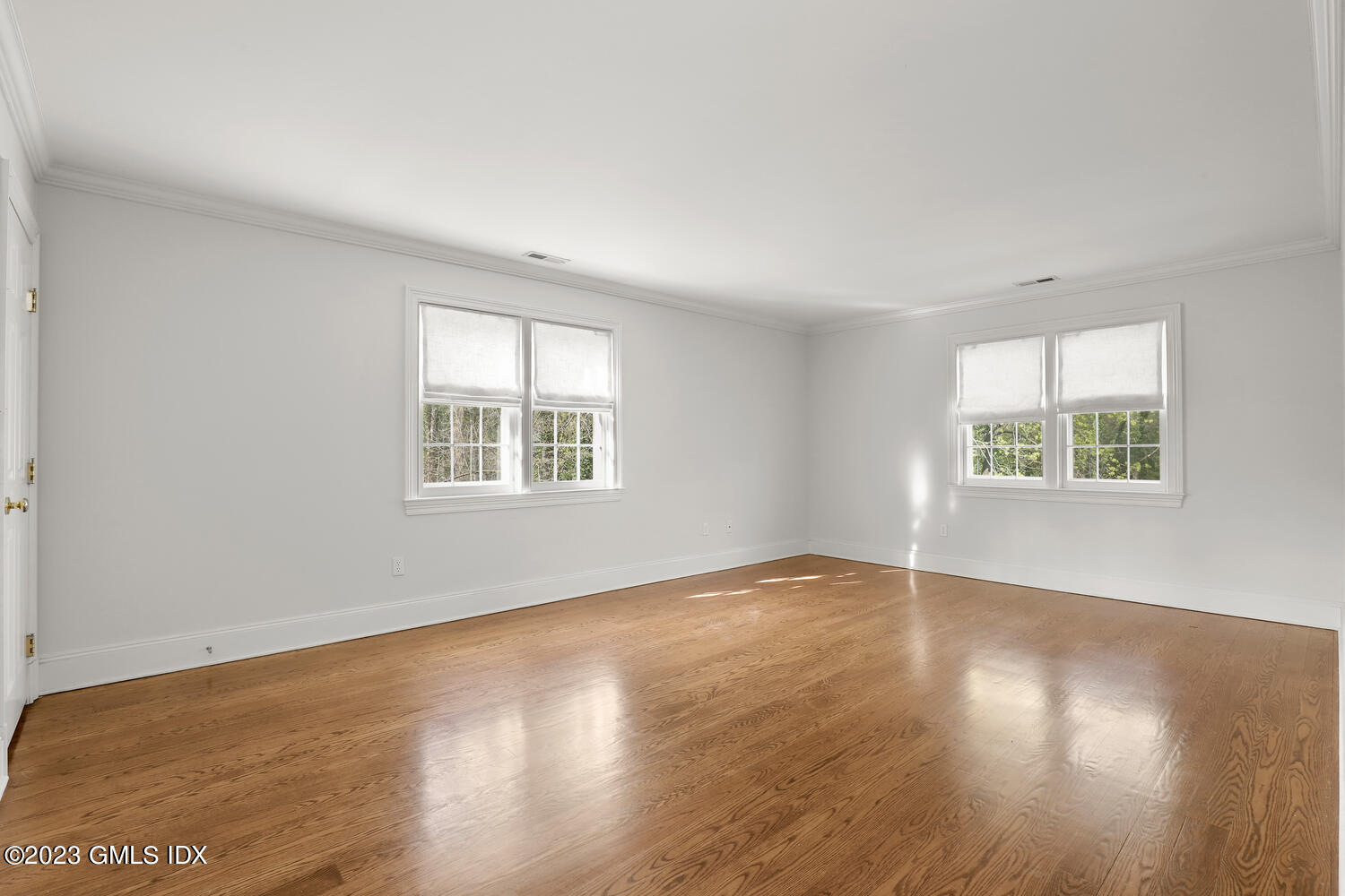 31 Fairfield Road Greenwich, CT 06830 - Photo 16 of 28 an empty room with wooden floor and windows