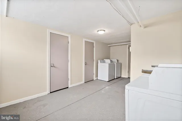 a view of a room with furniture and refrigerator