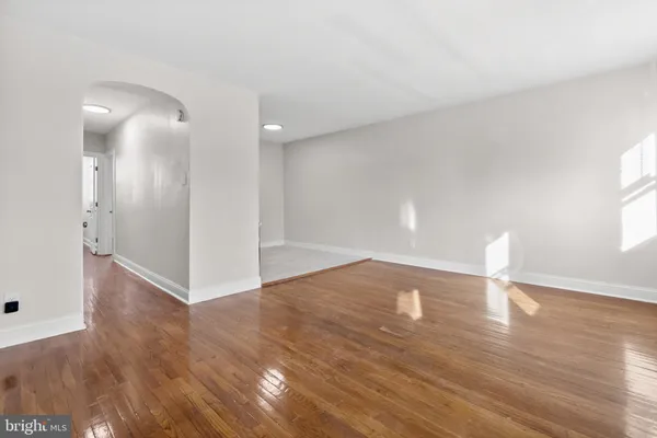 a view of an empty room and wooden floor