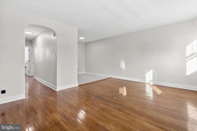 a view of an empty room and wooden floor