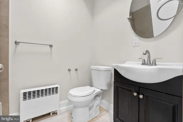 a bathroom with a sink a mirror and a toilet