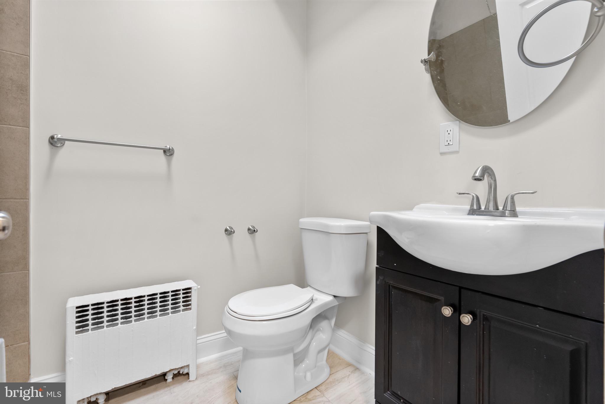5156 D Street, Unit 2 Philadelphia, PA 19120 - Photo 9 of 23 a bathroom with a sink a mirror and a toilet