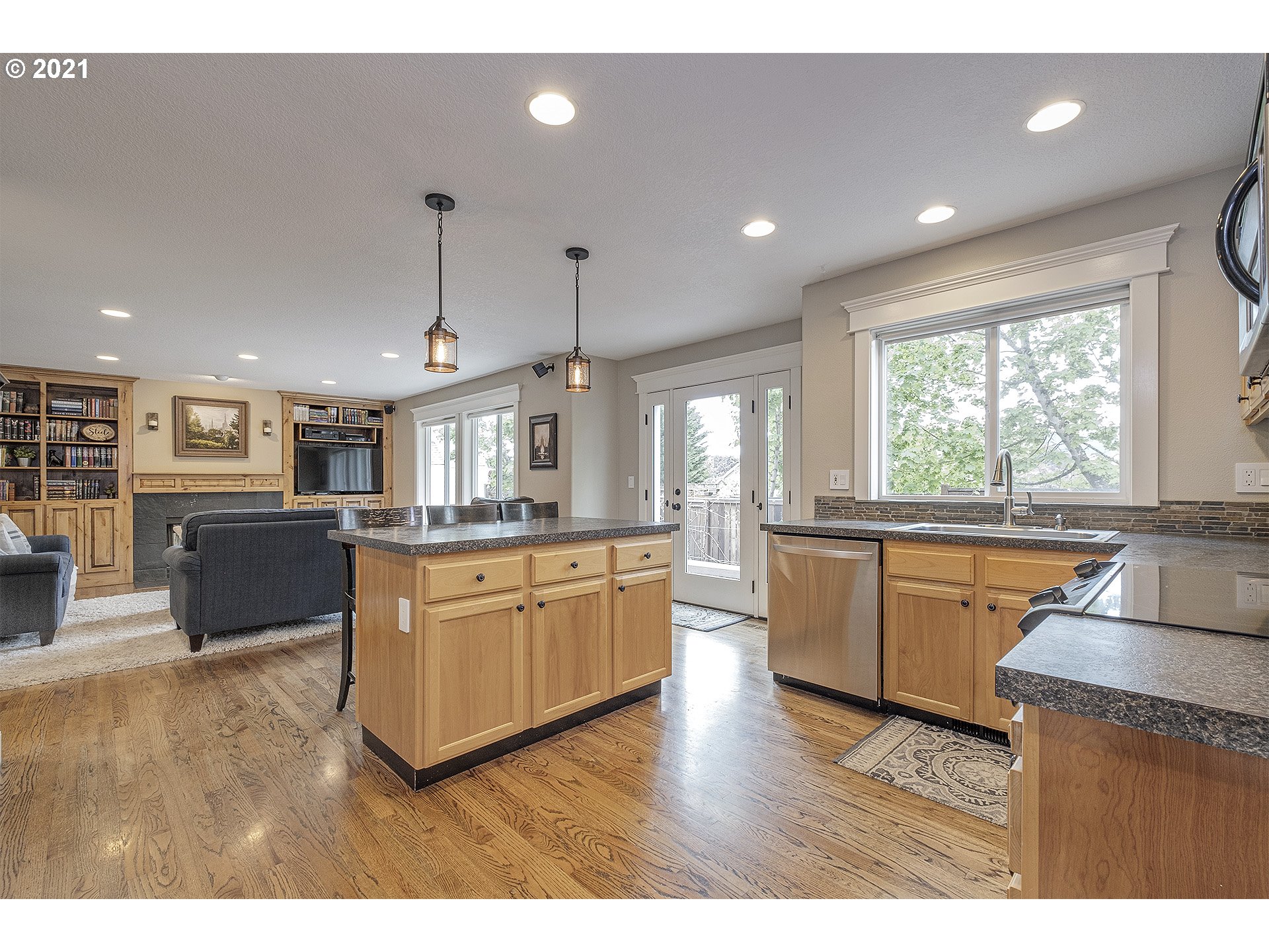 716 Roxe Drive Forest Grove, OR 97116 - Photo 14 of 32 a large kitchen with kitchen island a large counter top space a sink a window and stainless steel appliances