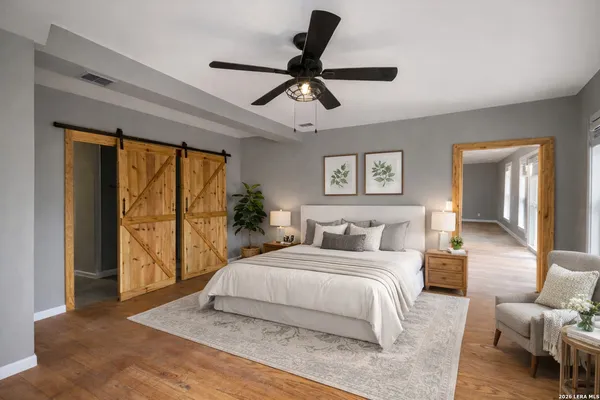 a bedroom with a large bed and a couch