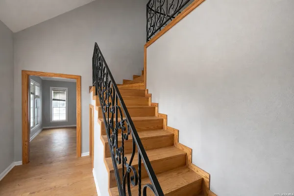a view of entryway and hall with wooden floor