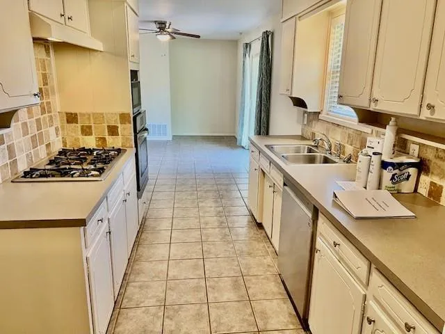 a kitchen with sink a stove and refrigerator