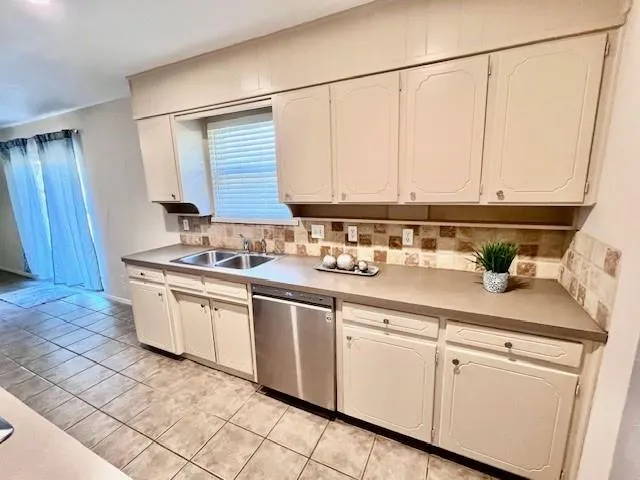 a kitchen with stainless steel appliances granite countertop a sink and cabinets