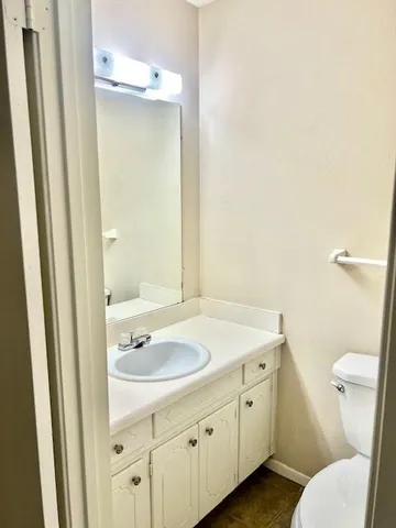 a bathroom with a sink a toilet and a mirror
