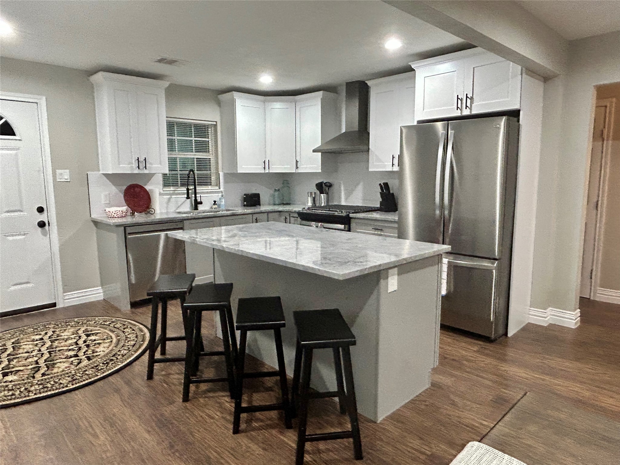 4010 Chapman Street Houston, TX 77009 - Photo 2 of 22 a kitchen with stainless steel appliances granite countertop a table chairs sink refrigerator and cabinets