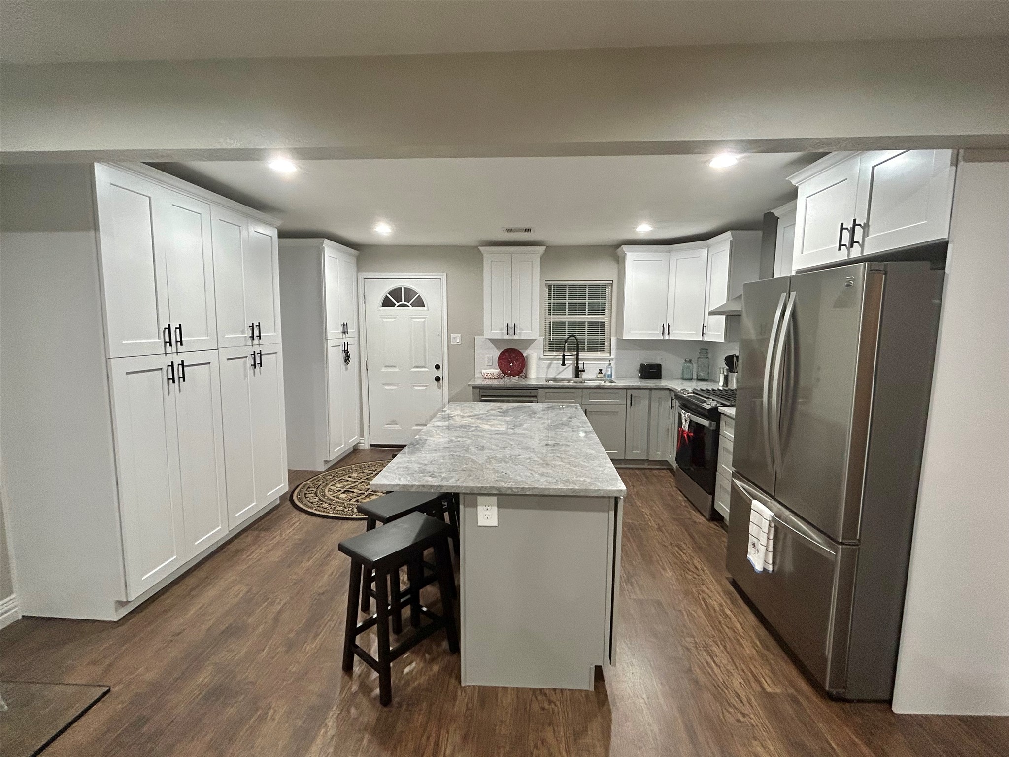 4010 Chapman Street Houston, TX 77009 - Photo 8 of 22 a kitchen with refrigerator a sink and wooden floor