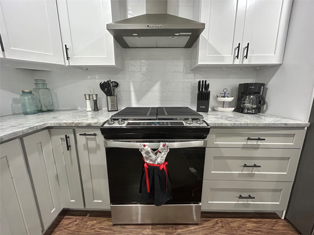 4010 Chapman Street Houston, TX 77009 - Photo 9 of 22 a kitchen with stainless steel appliances granite countertop a stove and a cabinets